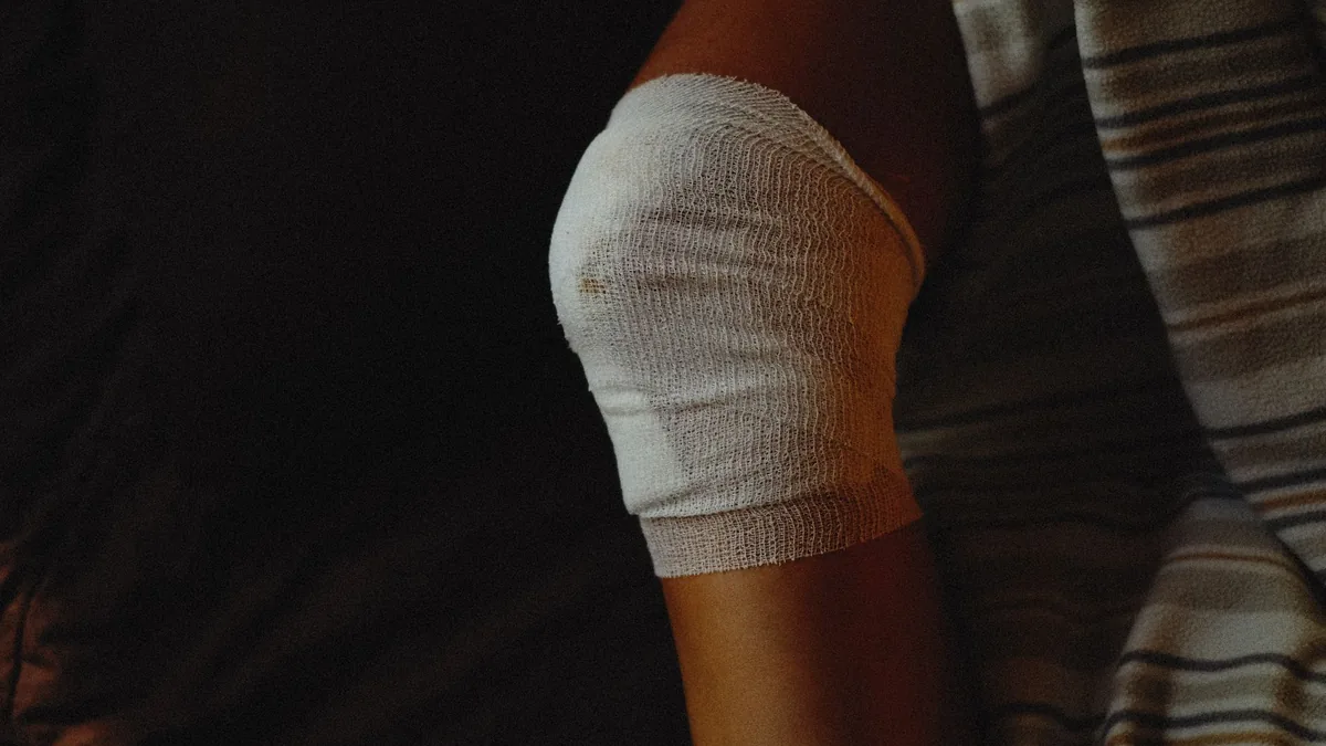 A detailed view of a bandaged knee indicating injury care and healing process.
