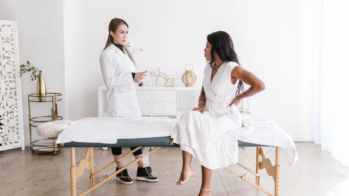 A doctor consulting a patient in a well-lit modern office setting.