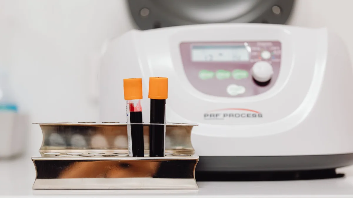 Blood samples in a rack with centrifuge in a laboratory environment.