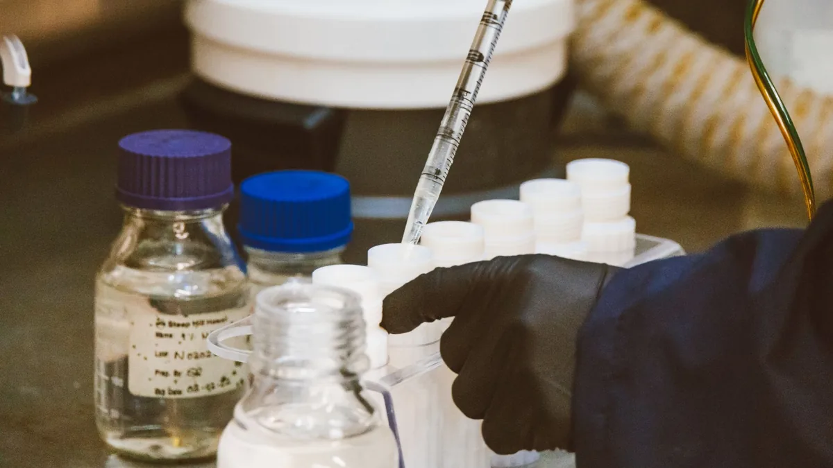 Detailed view of laboratory equipment and pipette in use, enhancing scientific research.