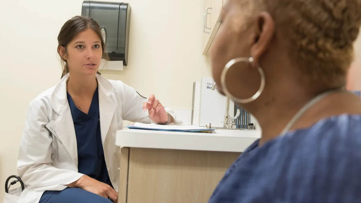 Doctor in consultation with patient at a medical clinic, discussing treatment options.