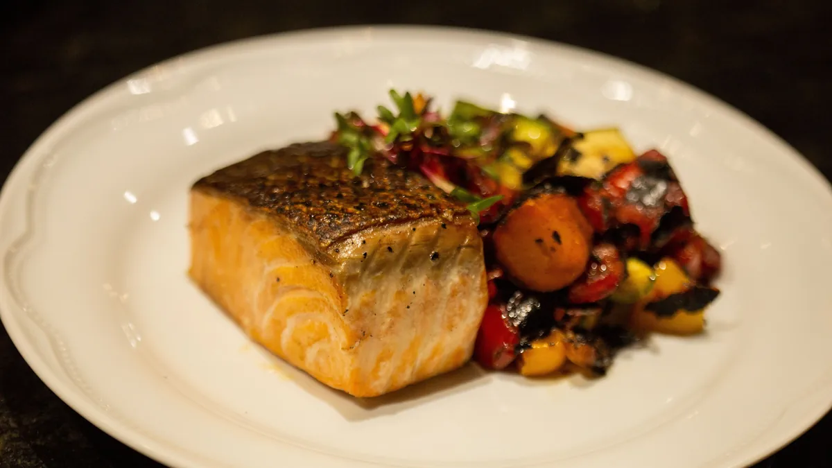 Plate of seared salmon with roasted vegetables