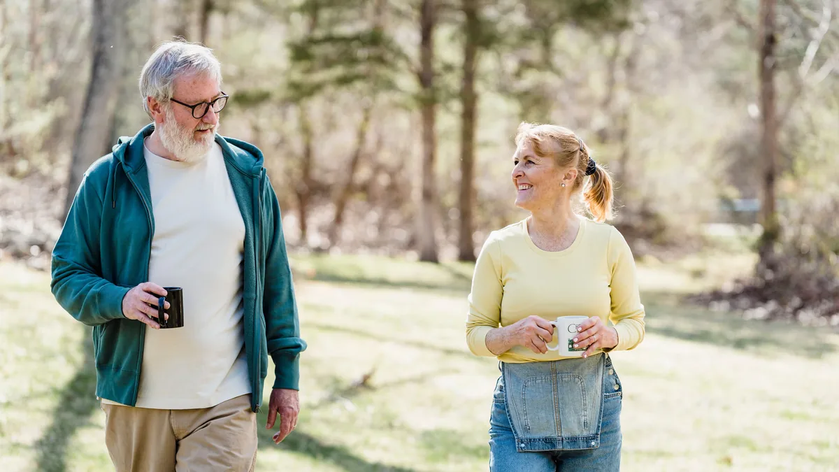 Older man and woman talking and smiling on an outdoor walk